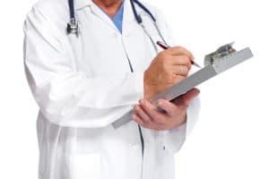 Doctor writing prescription on pad