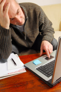 Unemployed veteran working on laptop computer