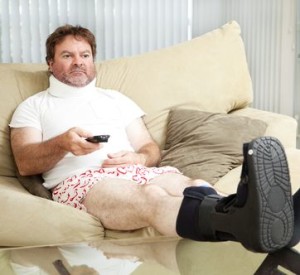 Depressed man sitting on couch after workers' compensation injury