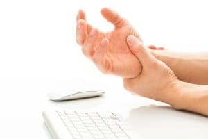 Pain from carpal tunnel syndrome from repetitive work on keyboard
