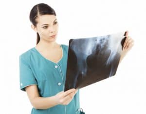 Female doctor looking at x ray image of hip