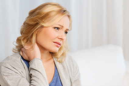 Unhappy woman suffering from neck pain