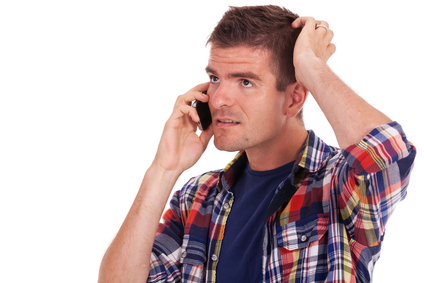 Confused man talking on cell phone