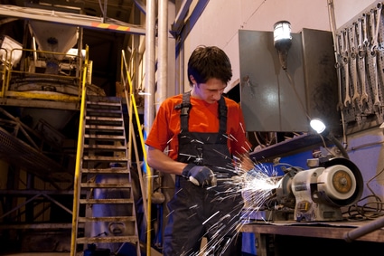 Technician operates a grinder